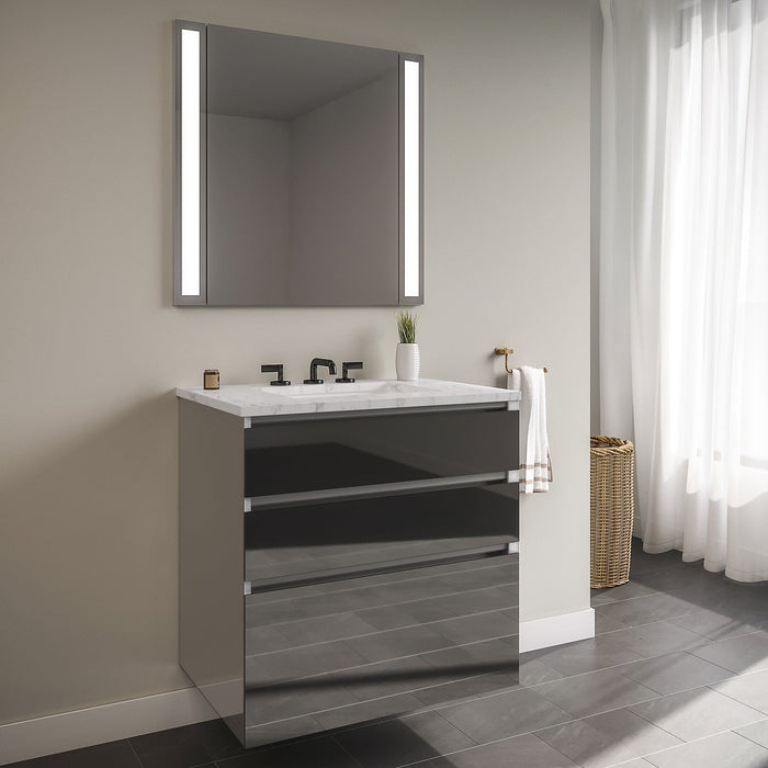 Curated Cartesian 24" x 7-1/2" x 21" and 24" x 15" x 21" three drawer vanity in tinted gray mirror glass with tip out drawer, slow-close plumbing drawer, full drawer and Engineered Stone 25" vanity top in Silestone lyra