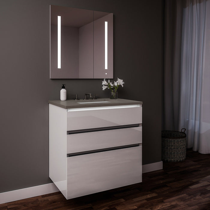 Curated Cartesian 30" x 7-1/2" x 21" and 30" x 15" x 21" three drawer vanity in white glass with tip out drawer, slow-close plumbing drawer, full drawer, night light and Engineered Stone 31" vanity top in stone gray (Silestone expo grey)