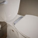 KOHLER K-36594-CP Covert ReadyLatch® Quiet-Close™ Round-front Toilet Seat, White - Shows close up detail of product in room